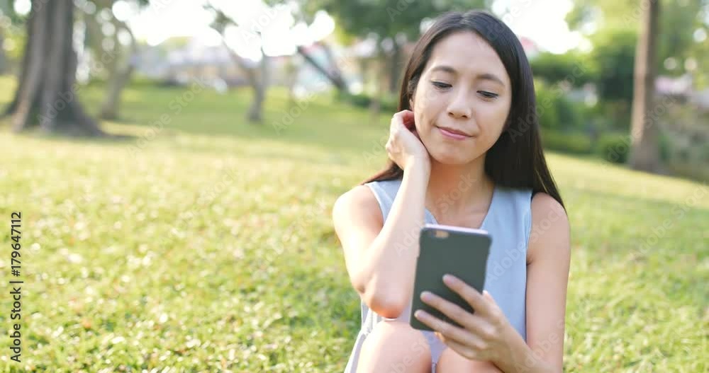 Woman watching on mobile phone at outdoor