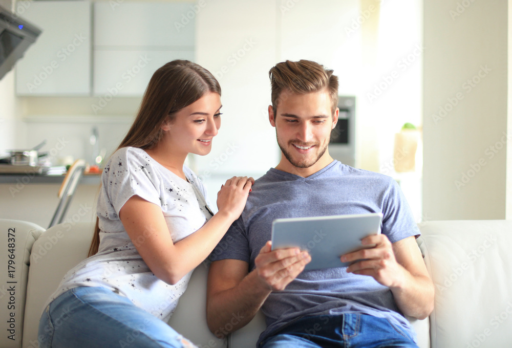 Happy couple in love surfing on tablet at home. Happy couple in love surfing on tablet at home.