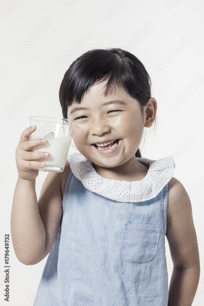 Pretty asian girl hand holding a cup of milk with smile isolated white. Pretty asian girl hand holding a cup of milk with smile isolated white.