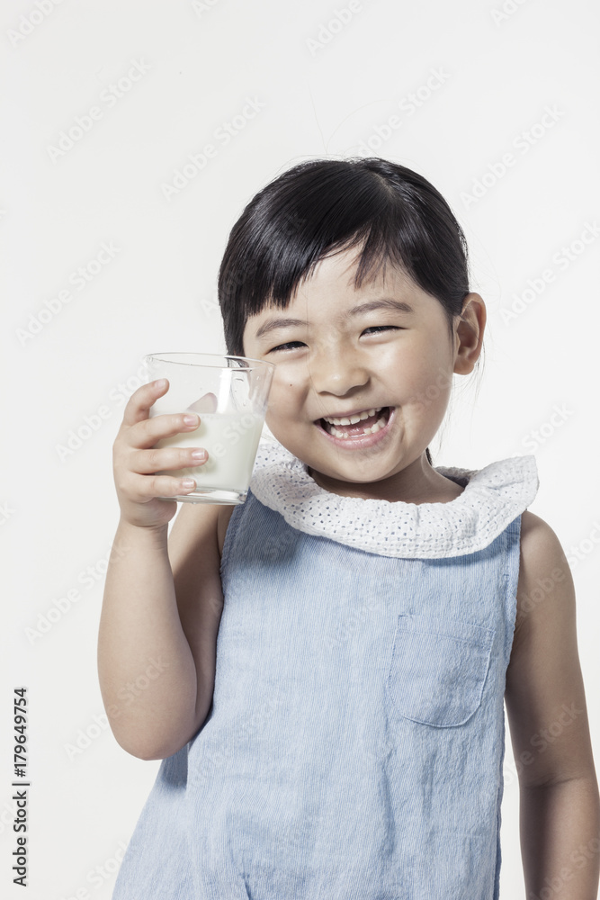 Pretty asian girl hand holding a cup of milk with smile isolated white. Pretty asian girl hand holding a cup of milk with smile isolated white.