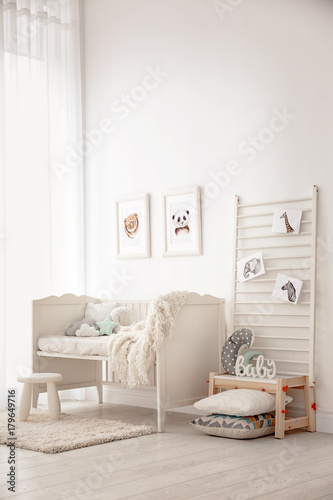 Baby bedroom decorated with pictures of animals photo