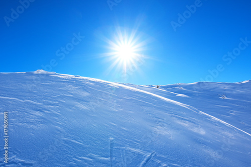 Sun over mountain snow cap