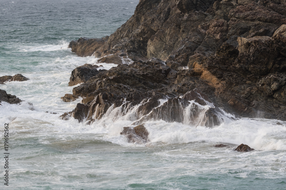 waves crashing on the rocks of the headland waves crashing on the rocks of the headland