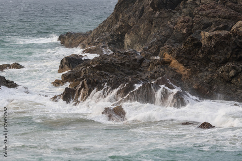 waves crashing on the rocks of the headland