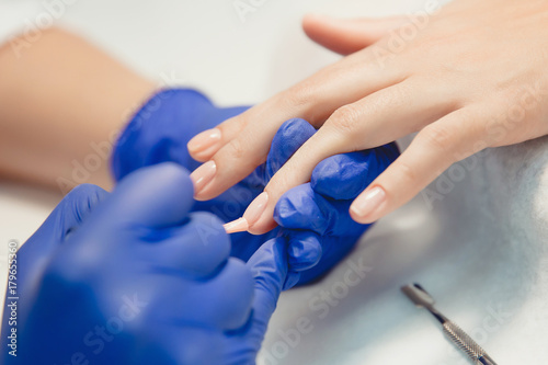 Manicure. Master does manicure on nails paint hand
