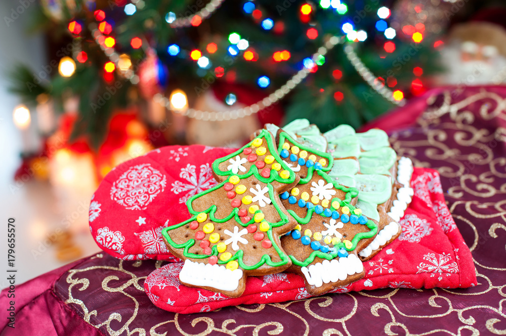 Homemade christmas tree shape gingerbread cookies on illuminated festive background