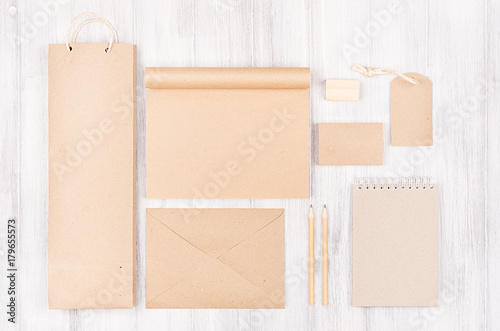 Corporate identity template, kraft packaging, stationery, gift  set on soft white wood background. Mock up for branding, advertising, design, business presentations and portfolios.