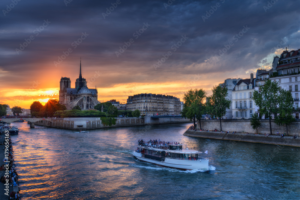 Notre Dame cathedral in Paris, France against sunset sky. Scenic skyline. Colourful travel background.