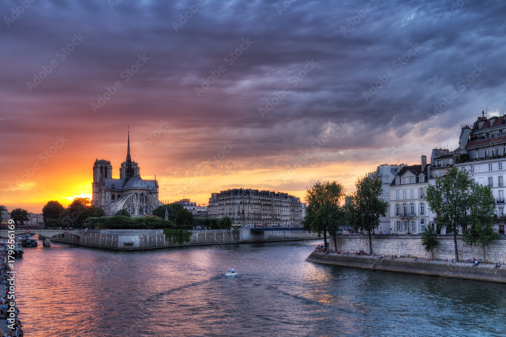 Spectacular view over la Cite in Paris, France, against dramatic sunset sky. Scenic skyline with Notre Dame cathedral. Colourful travel background.