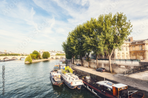 Picturesque view over la Cite in Paris, France, from the Arts bridge on a summer day with the river Seine and cruise boats. Daytime skyline. Popular travel destination.