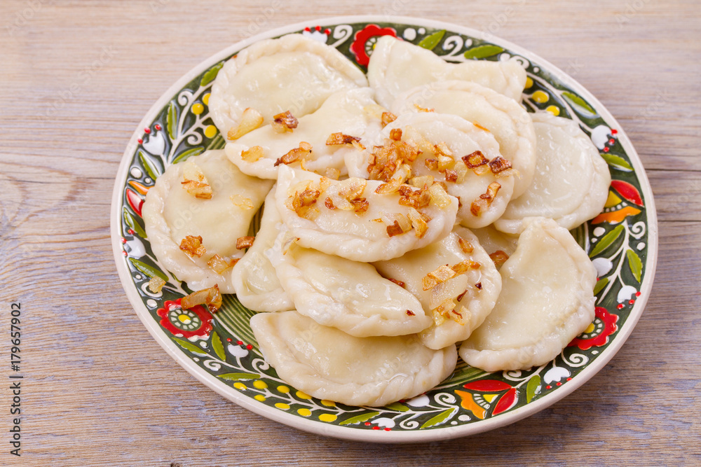 Dumplings, filled with potato and served with salty caramelized onion. Varenyky, vareniki, pierogi, pyrohy - popular dish in East Europe, horizontal