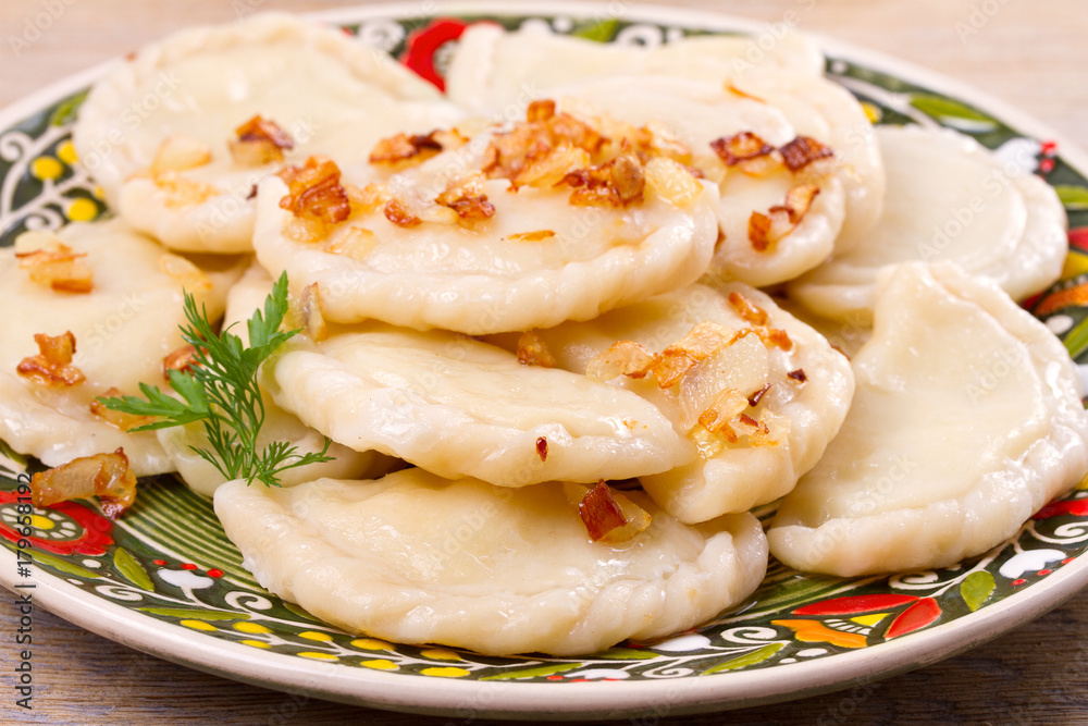 Dumplings, filled with potato and served with salty caramelized onion. Varenyky, vareniki, pierogi, pyrohy - popular dish in East Europe, horizontal Dumplings, filled with potato and served with salty caramelized onion. Varenyky, vareniki, pierogi, pyrohy - popular dish in East Europe, horizontal