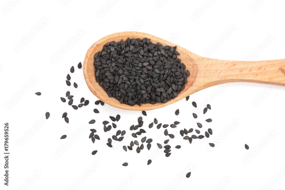 Black sesame seeds in a wooden spoon isolated on white background top view Black sesame seeds in a wooden spoon isolated on white background top view