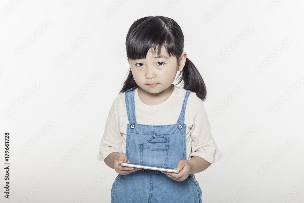 pretty asian girl hand holding a digital device(smart phone), stand up isolated white pretty asian girl hand holding a digital device(smart phone), stand up isolated white
