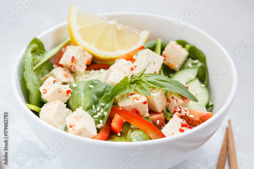 Vegan healthy salad with paprika tofu and vegetables.