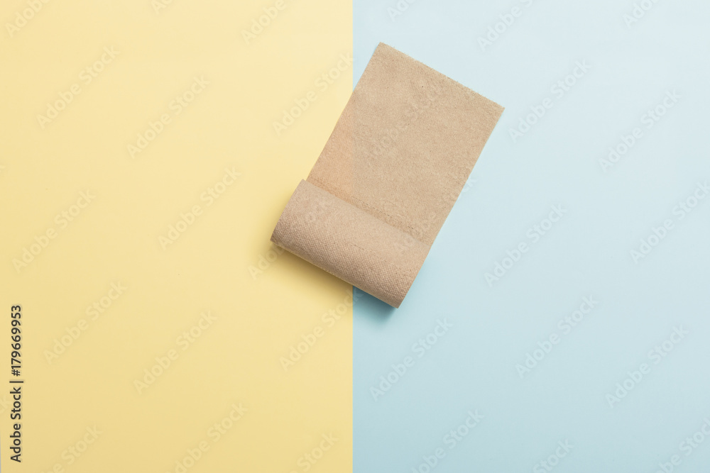 brown rolling paper on the color(yellow, blue) paper background. brown rolling paper on the color(yellow, blue) paper background.