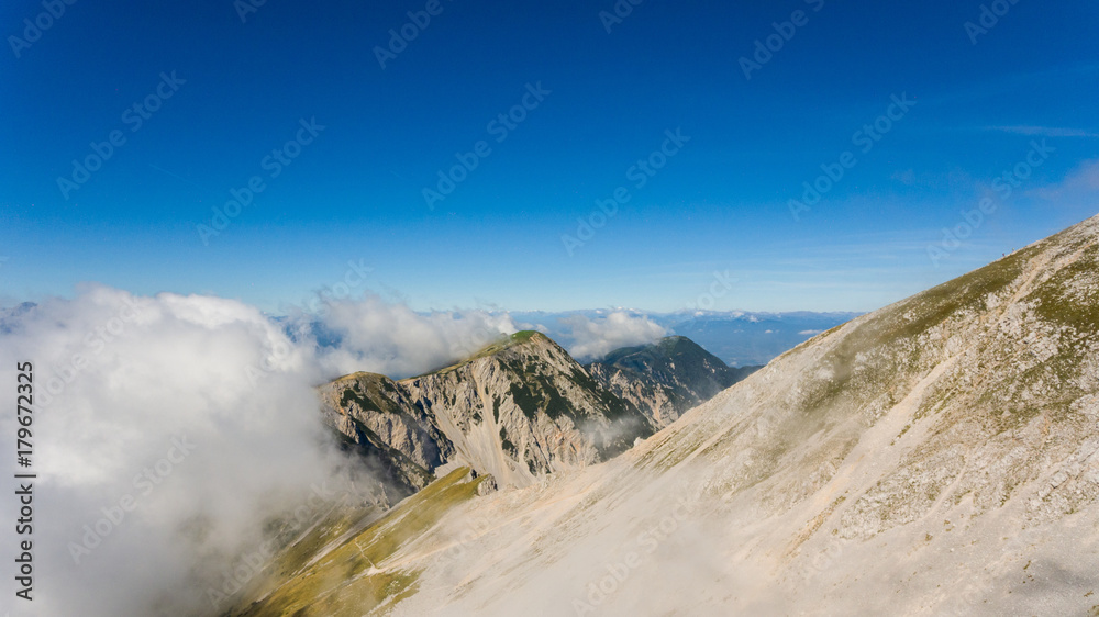 Aerial view of mountain ridge surrounded with clouds. Aerial view of mountain ridge surrounded with clouds.