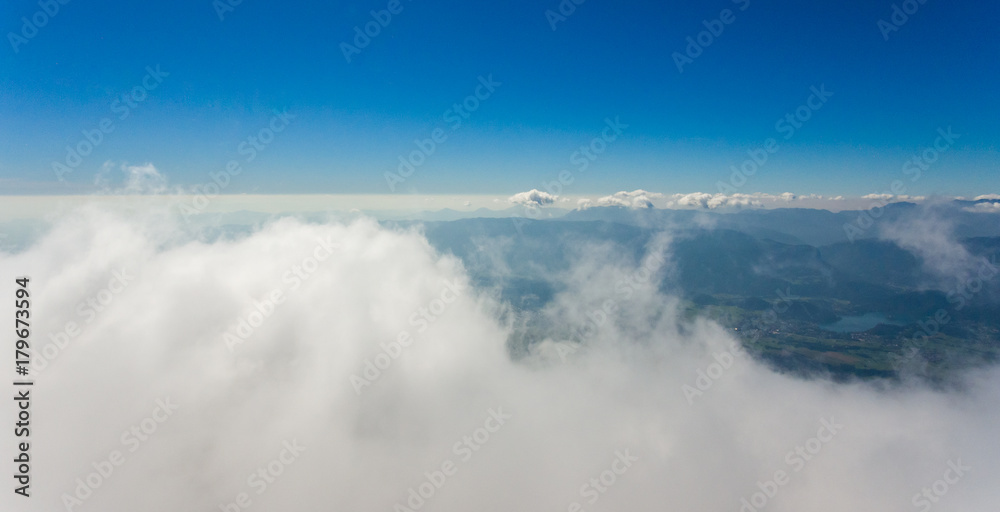 Aerial flying above clouds.