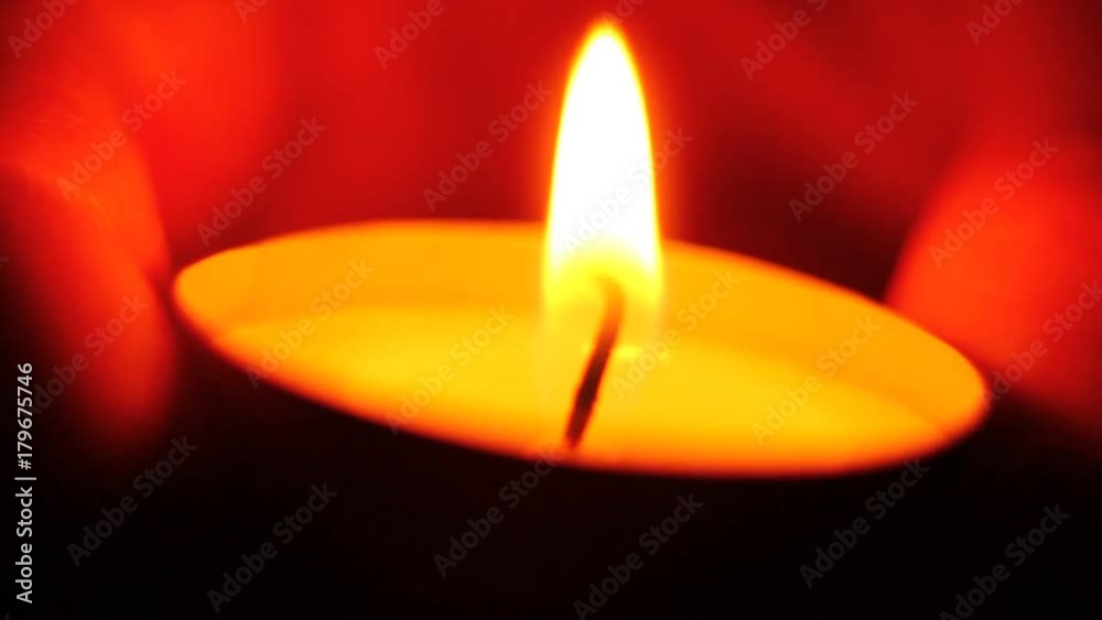 Warm and nice light around slowly burning down tea candle between male fingers. Macro clip. Little shallow dept of field (DOF). Warm and nice light around slowly burning down tea candle between male fingers. Macro clip. Little shallow dept of field (DOF).