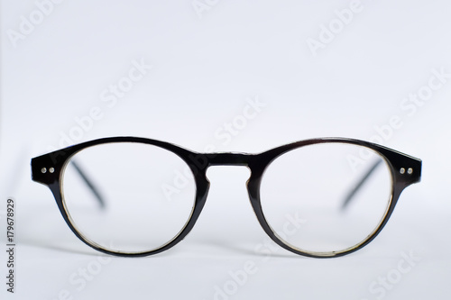 Fototapeta Naklejka Na Ścianę i Meble -  Eyeglasses with black frame on white scene