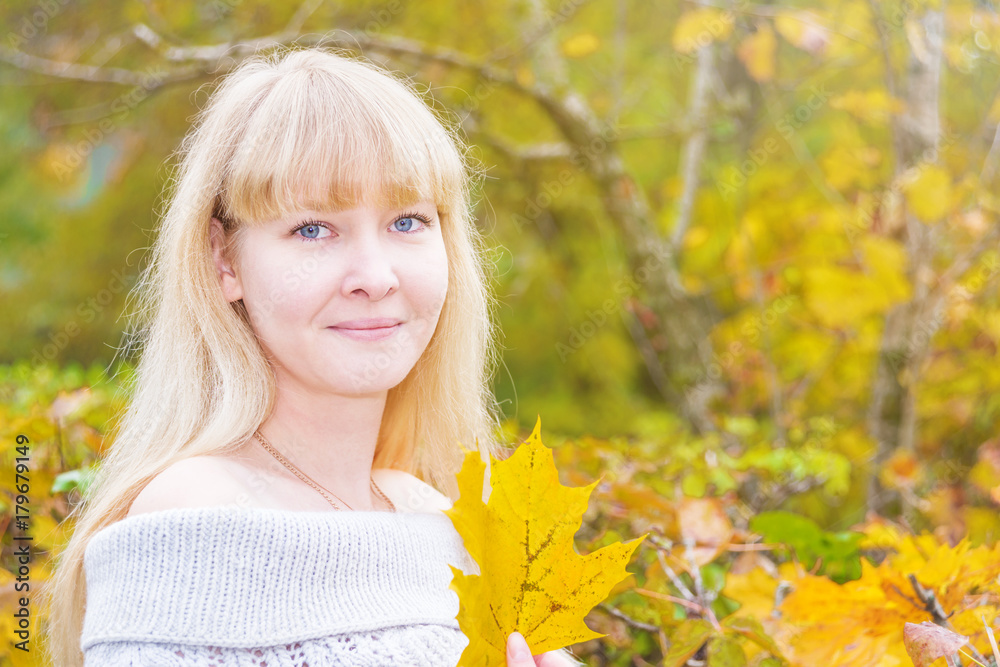 Blue-eyed blonde in an autumn park Blue-eyed blonde in an autumn park