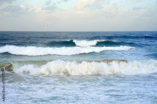 Fototapeta Naklejka Na Ścianę i Meble -  Beautiful wave on the beach. Early morning and strong wind. Cloudy morning.