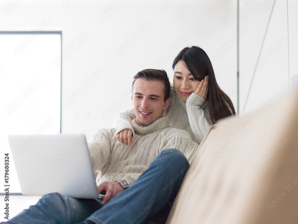 multiethnic couple using laptop computers multiethnic couple using laptop computers