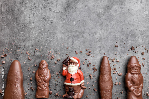 Delicious Christmas chocolate and sweets on rustic background