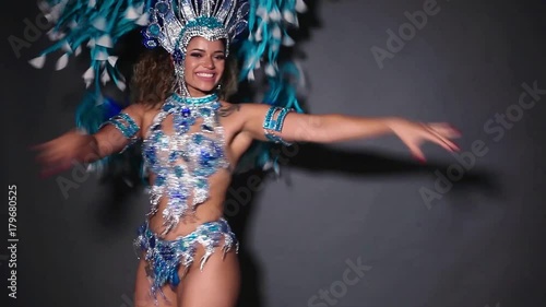 Beautiful and happy brazilian woman dancing samba and wearing traditional costume