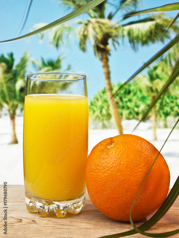 Glass of orange juice on a beach Glass of orange juice on a beach
