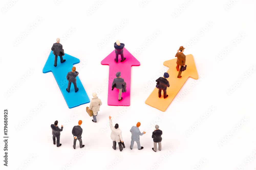 Miniature people,Businessman leader standing on arrow to select way go ahead,business concept Miniature people,Businessman leader standing on arrow to select way go ahead,business concept