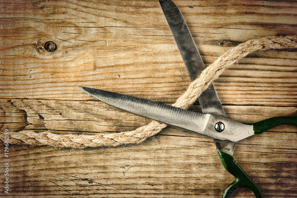 old tailor scissors and rope on the wooden background old tailor scissors and rope on the wooden background