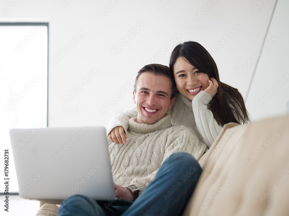 multiethnic couple using laptop computers multiethnic couple using laptop computers