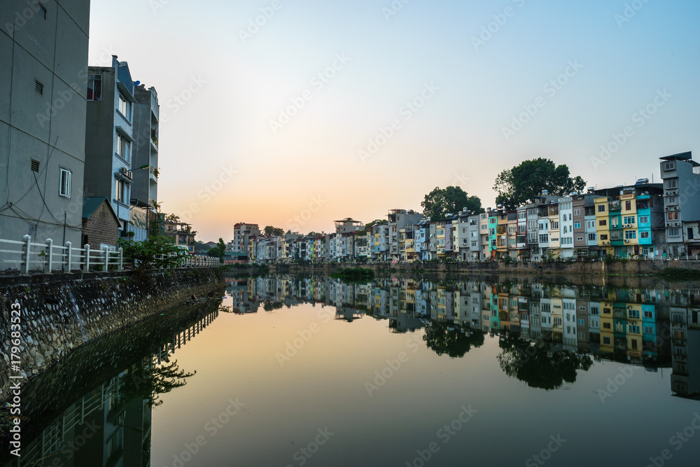 Fototapeta premium Resident houses and reflection on Tinh Bien lake in Hanoi, Vietnam