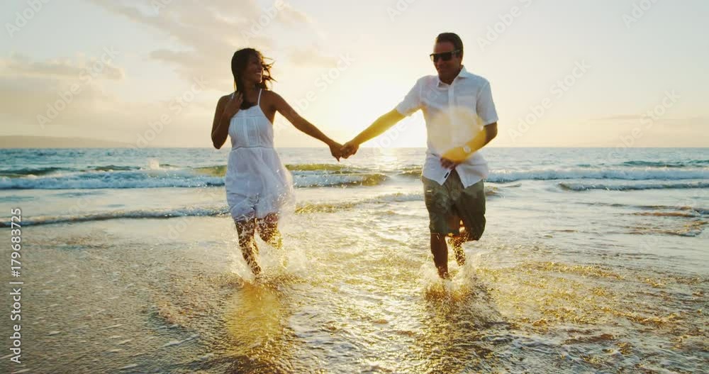 Happy Couple on the Beach at Sunset Happy Couple on the Beach at Sunset
