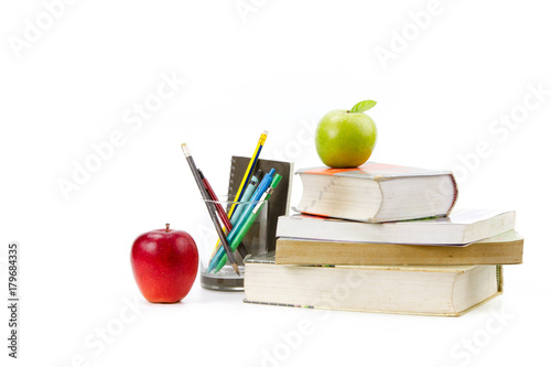 Books pens and apples isolated white background metaphor knowledge or homework and school concept. photo