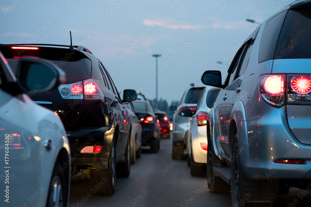 Cars on urban street in traffic jam at twilight Cars on urban street in traffic jam at twilight