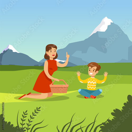 Happy mother and son having picnic