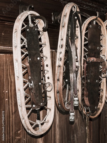 Vintage wooden snowshoes hanging on the wall in mountain cottage. photo