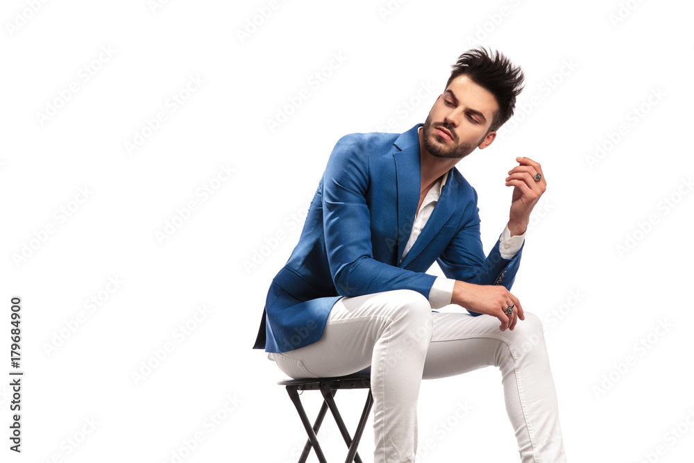 seated elegant man looks back over his shoulder seated elegant man looks back over his shoulder