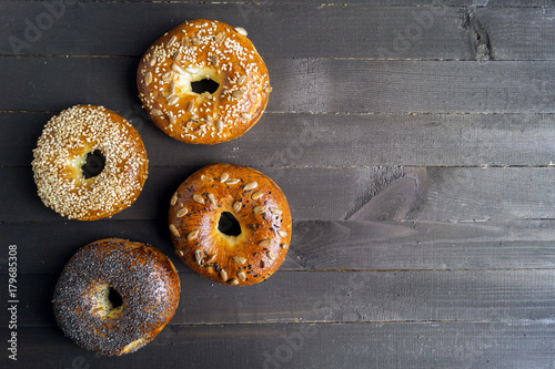 Bagels with seeds on a black background.