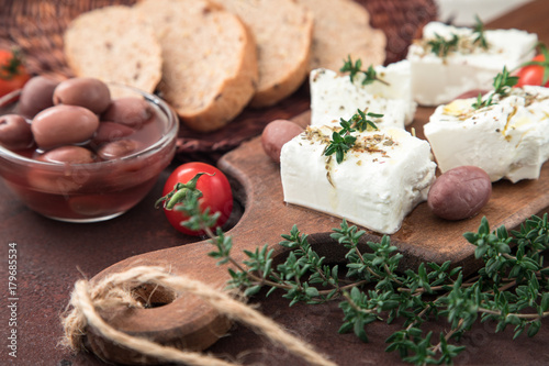 Greek cheese feta with thyme and olives. selective focus, copy space