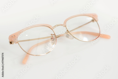 Pink glasses with clear lenses on the white background