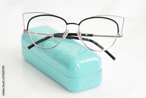 Glasses case with fashionable glasses on white background