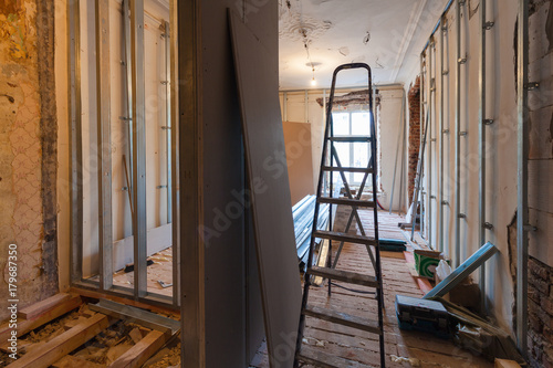 Interior of upgrade apartment with materials during on the remodeling, renovation, extension, restoration, reconstruction and construction. ( making wall from gypsum plasterboard) photo