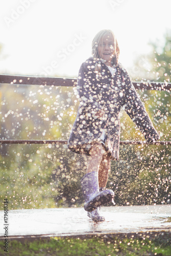little girl enjoy happy in puddles of water © karrastock
