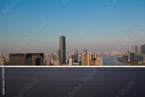 Empty road surface floor with city landmark buildings of Shanghai Skyline © Aania