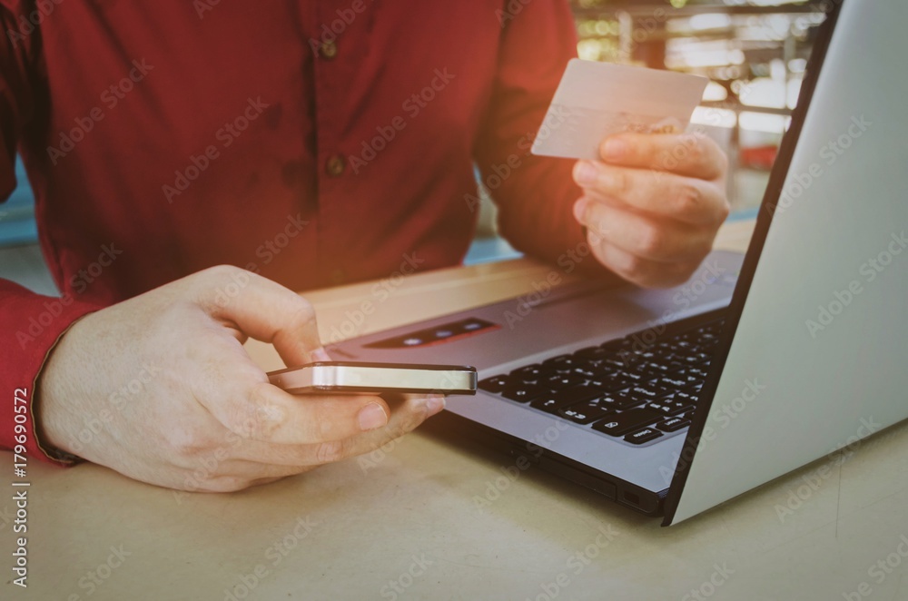 young man entering credit card security code with mobile smart phone