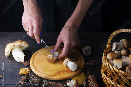 Female hands cut mushrooms not a kitchen board