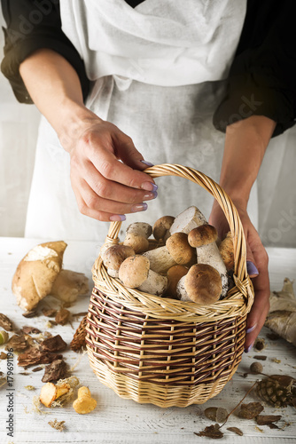 woman holding a basket with mushrooms